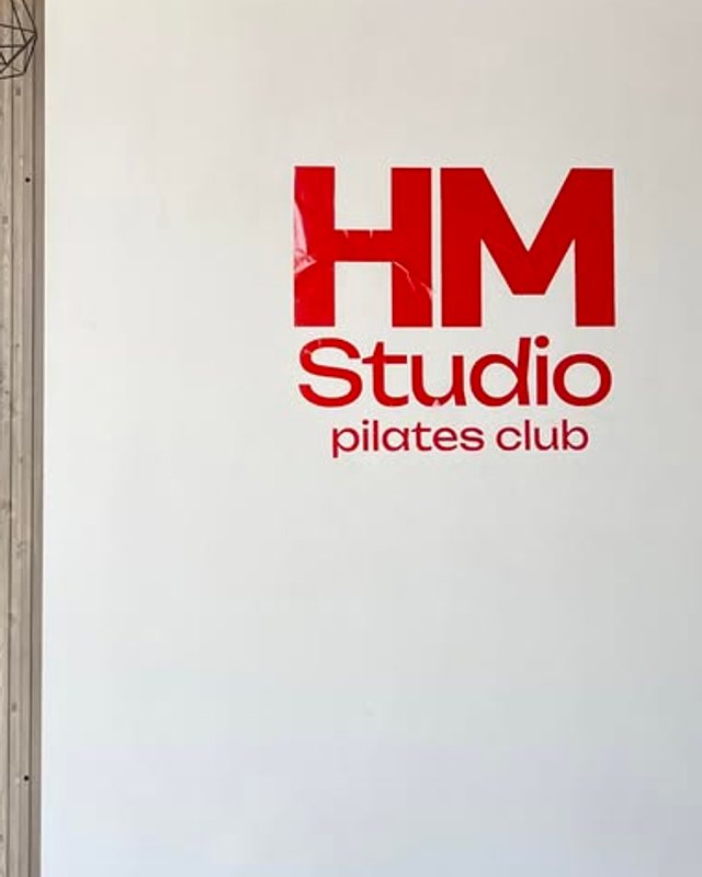 Muro del estudio con el logotipo de HM Studio Pilates Club